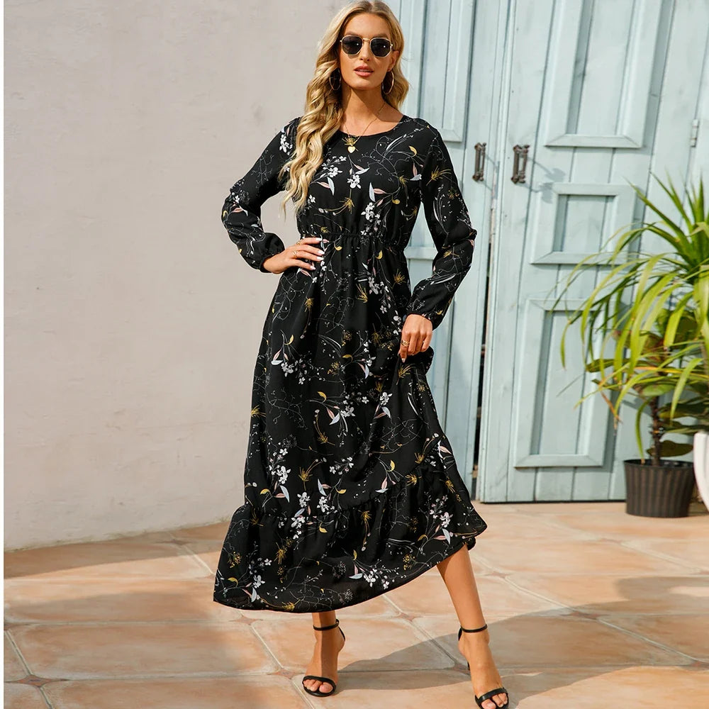 Black floral maxi dress with long sleeves, gathered waist, and tiered ruffle hem