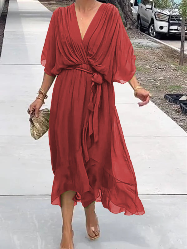 Red V-neck wrap summer dress with tied waist and loose flowing draped sleeves.
