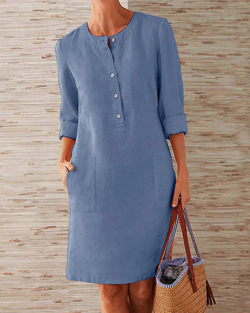 Blue button-front summer dress with three-quarter sleeves and side pockets