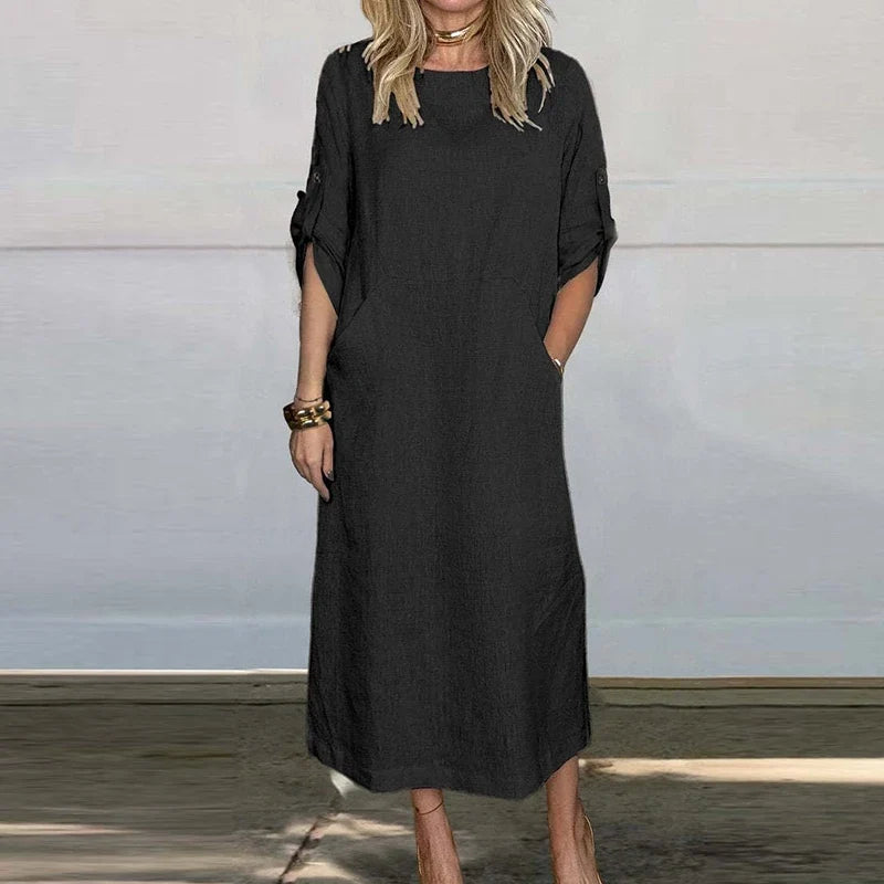 Black textured midi dress, crew neck, short sleeves with button details.