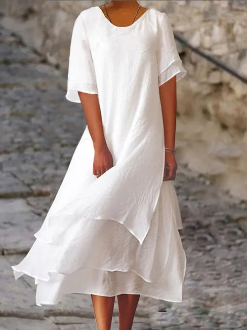 White long midi dress with short sleeves, round neck, and layered ruffle hem