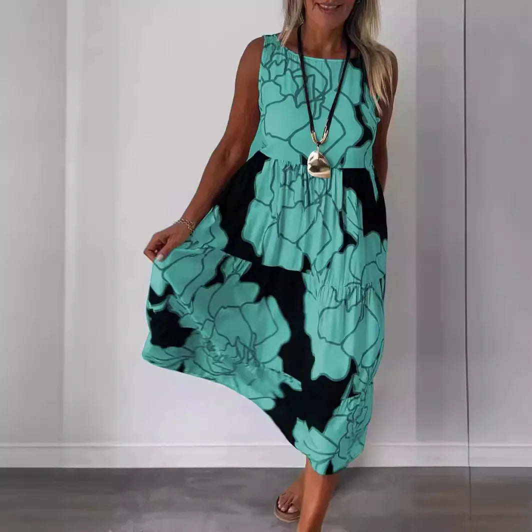 Sleeveless printed midi dress with round neckline and flowing tiered skirt, teal with dark accents.