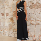 Black sleeveless one-shoulder maxi dress with zigzag trim at neckline, waist, and hem
