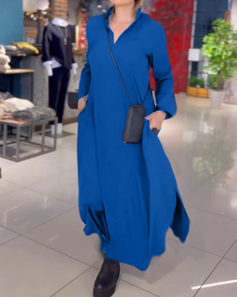 Blue V-neck maxi dress with three-quarter sleeves and wrap-style waist.