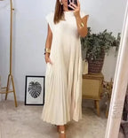 Ivory sleeveless pleated maxi dress with round neckline and flowing A-line skirt