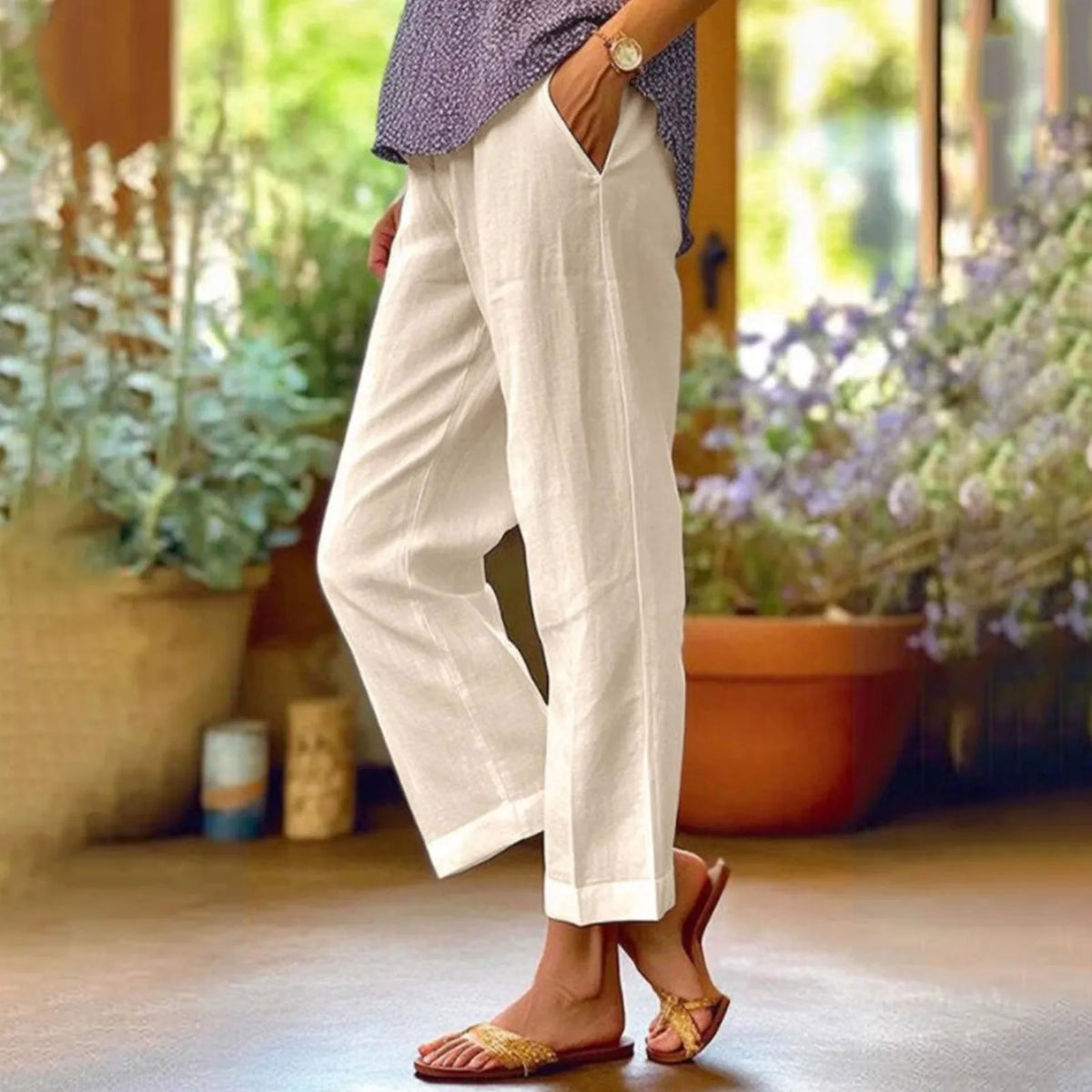 White ankle-length stretch pants with wide, straight cut.