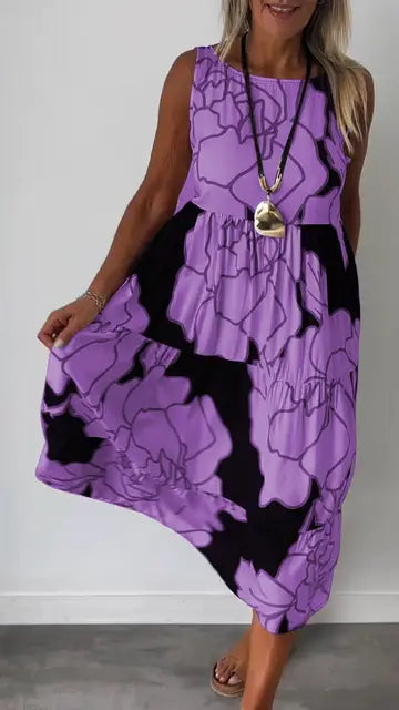 Sleeveless printed midi dress with round neckline and flowing tiered skirt, purple with dark trim.
