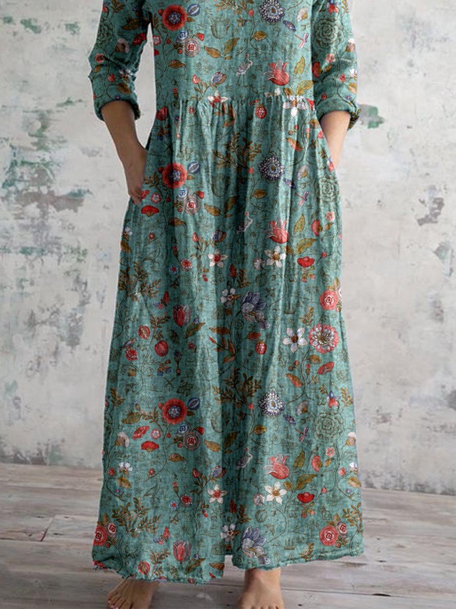 Teal patterned maxi dress with V-neck, tiered skirt, three-quarter sleeves