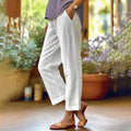 White ankle-length stretch pants with relaxed straight legs.
