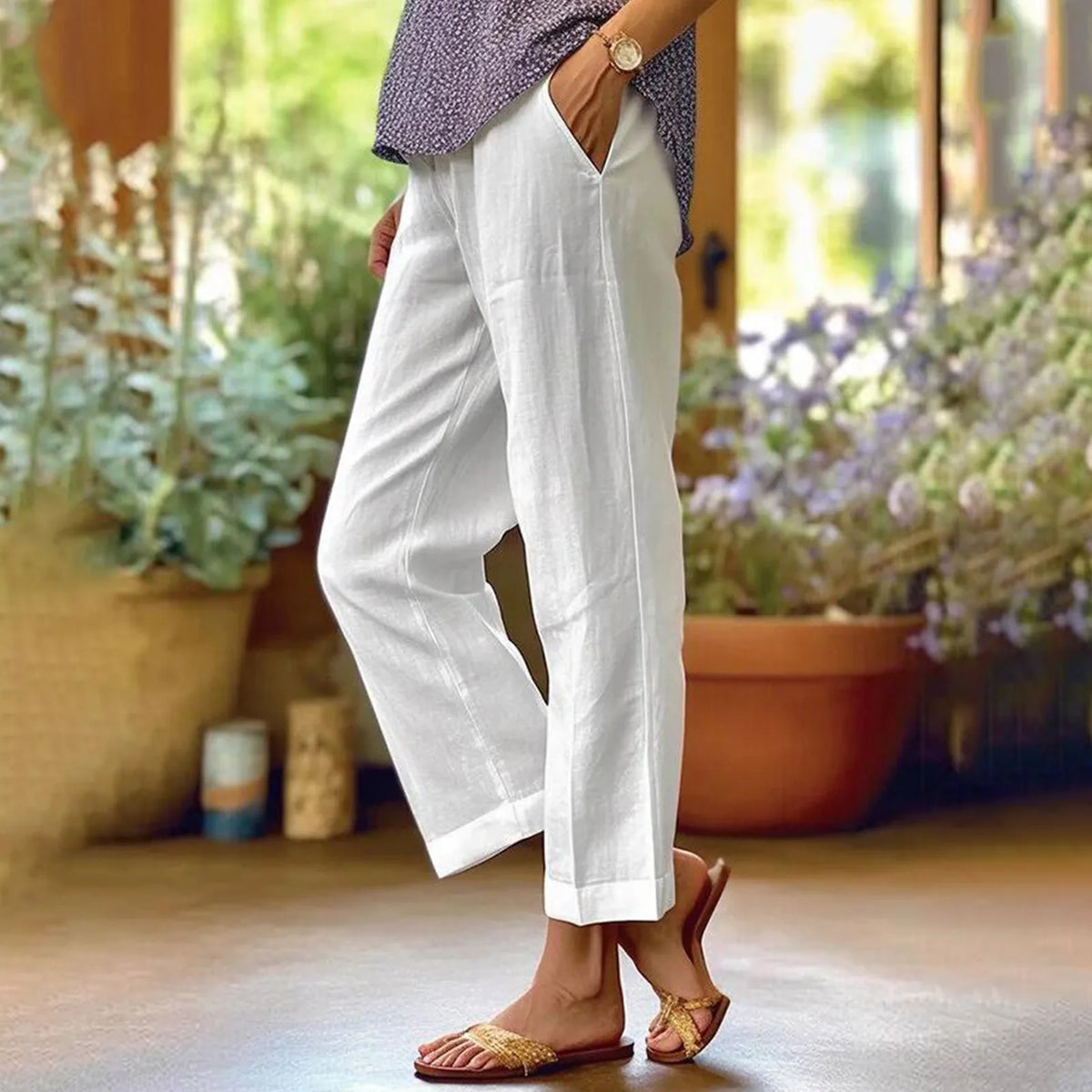 White ankle-length stretch pants with relaxed straight legs.