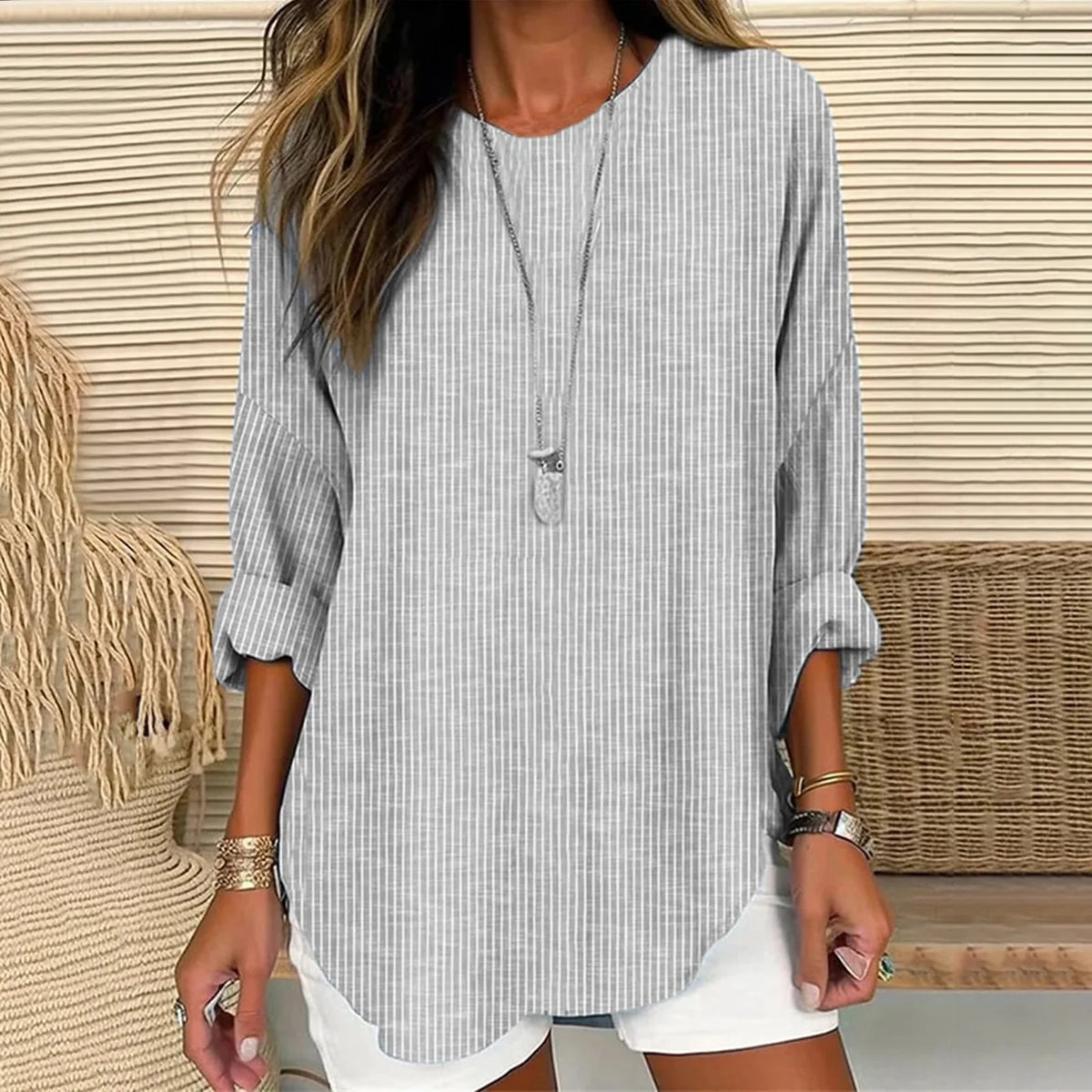 Light blue striped linen tunic top with long sleeves, keyhole neckline, curved hem