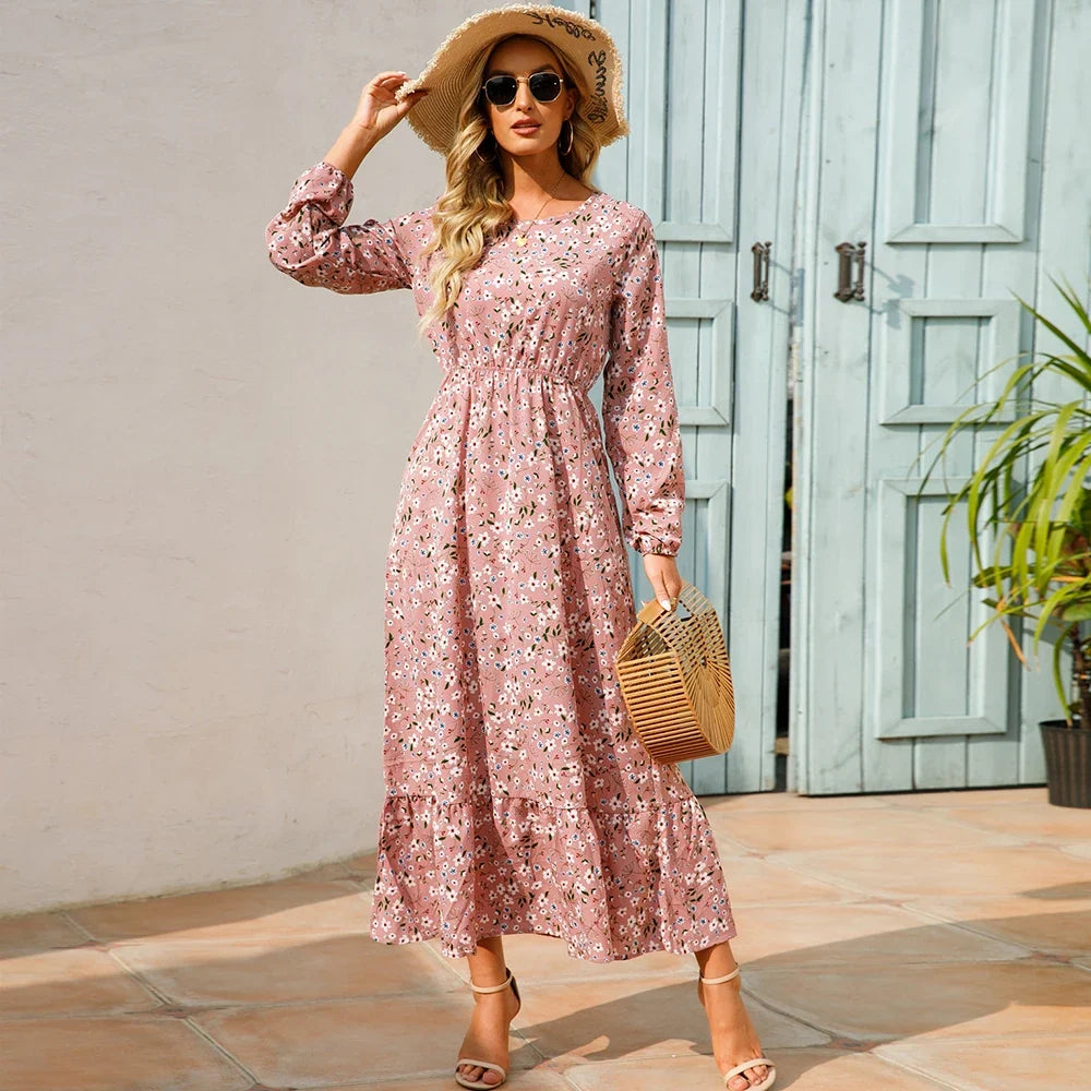 Pink floral maxi dress with long sleeves, elastic waist, and tiered skirt