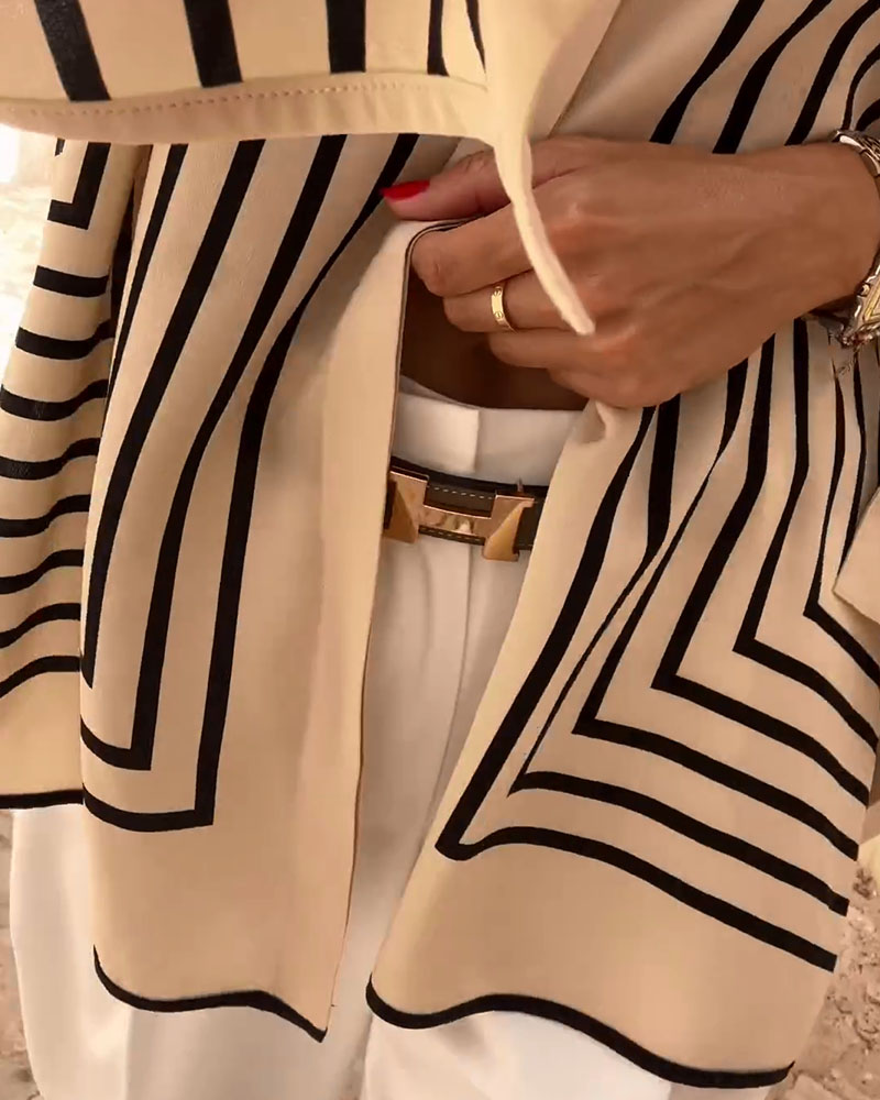 Clara™ elegant blouse close-up: cream with black geometric stripe trim and V-neck