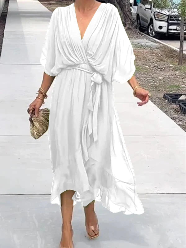White V-neck wrap summer dress with belted waist and billowy elbow-length sleeves.