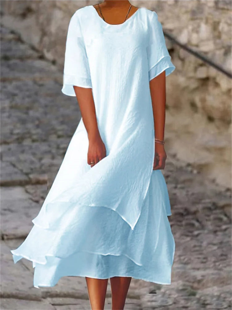 Light blue long midi dress with short sleeves, round neck, and layered ruffle hem