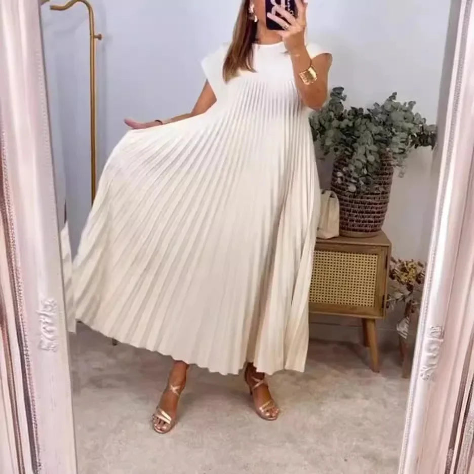 Cream pleated maxi dress with cap sleeves and flowing A-line skirt