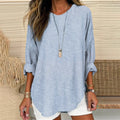 Blue striped linen tunic top with long sleeves, round neckline, curved hem