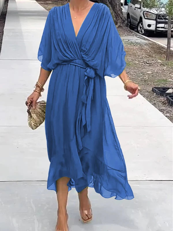 Blue V-neck wrap summer dress with tied waist and loose draped sleeves.