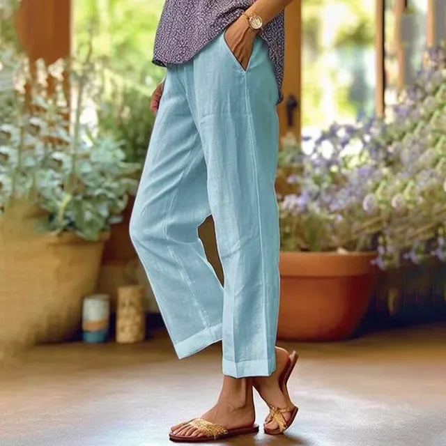 Blue ankle-length stretch pants with relaxed straight legs.