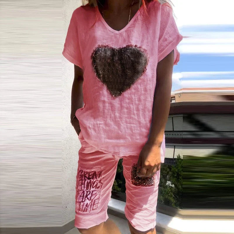 Pink V-neck T-shirt and shorts set with dark heart and text print