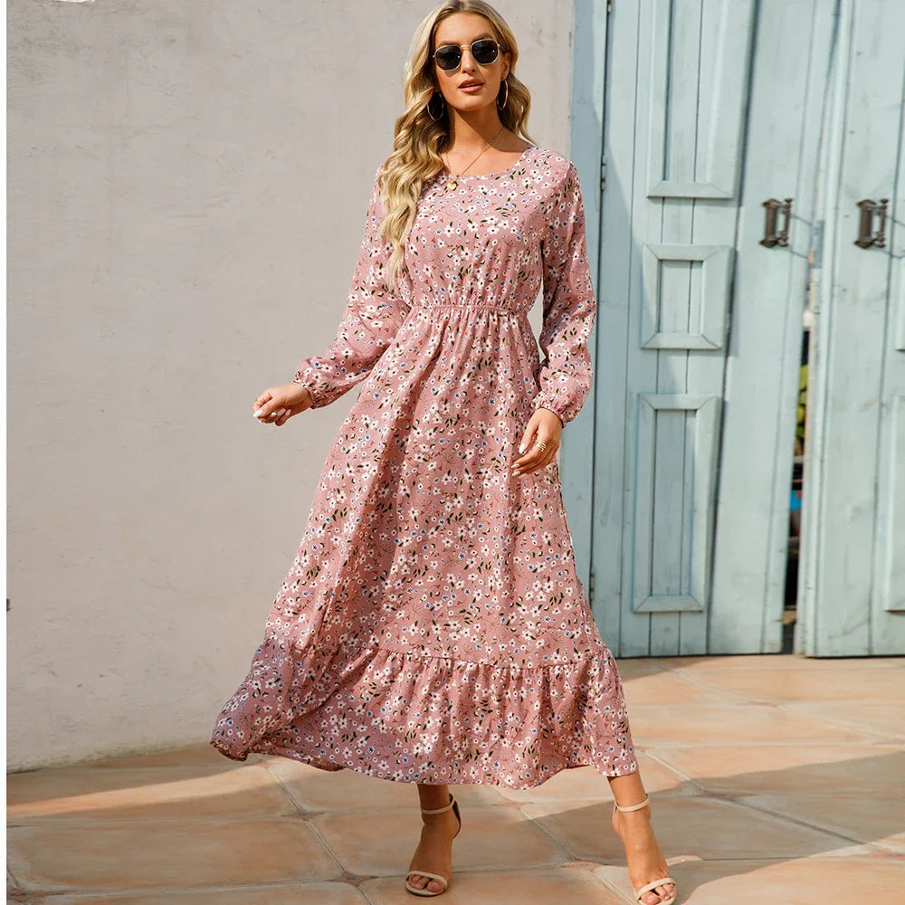 Pink floral maxi dress with long sleeves and gathered waist with tiered skirt