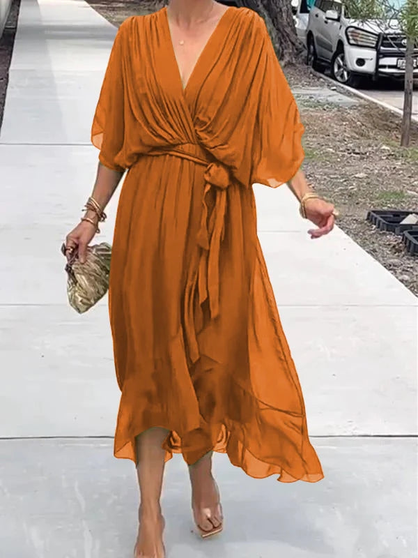 Orange V-neck wrap summer dress with waist tie and flowing draped sleeves.