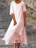 Blush pink long midi dress with short sleeves, round neck, and layered ruffle hem
