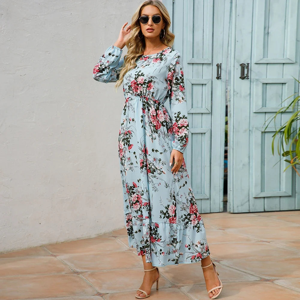 Light blue floral maxi dress with long sleeves, gathered waist, and tiered hem