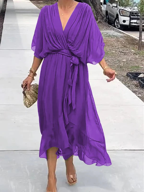 Purple V-neck wrap summer dress with belted waist and billowy draped sleeves.