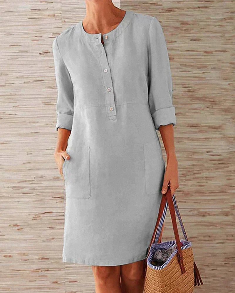 Light gray button-front summer dress with three-quarter sleeves and side pockets