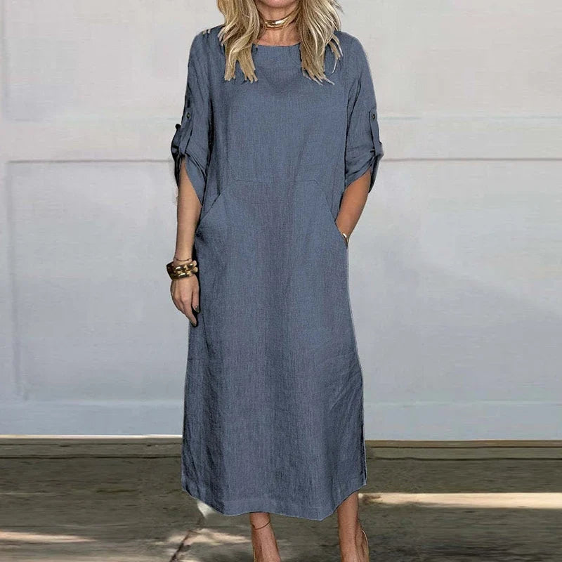 Blue textured midi dress, crew neck, short sleeves with button details.