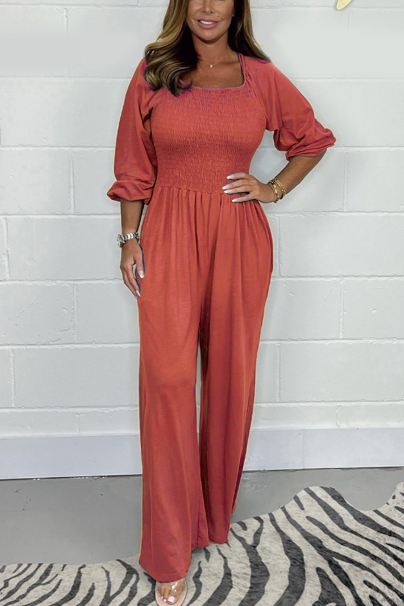Rust red square-neck jumpsuit set with elbow puff sleeves and wide-leg pants.