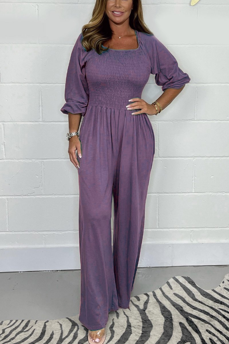 Purple square-neck jumpsuit set with elbow puff sleeves and wide-leg pants.