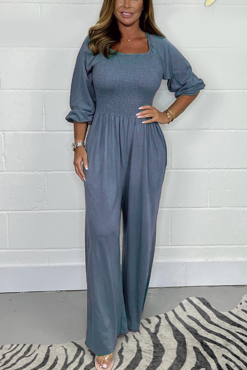 Steel blue square-neck jumpsuit set with elbow puff sleeves and wide-leg pants.