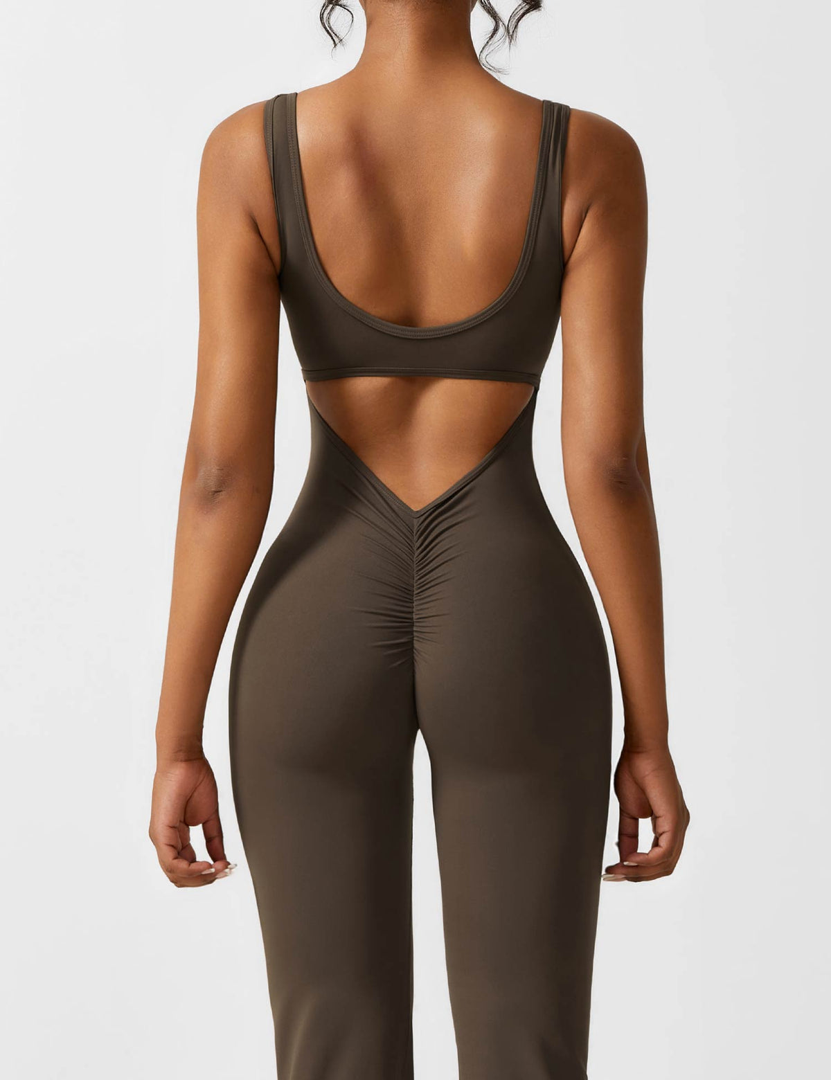 Black sports jumpsuit with open-back cutout and racerback-style sports bra top