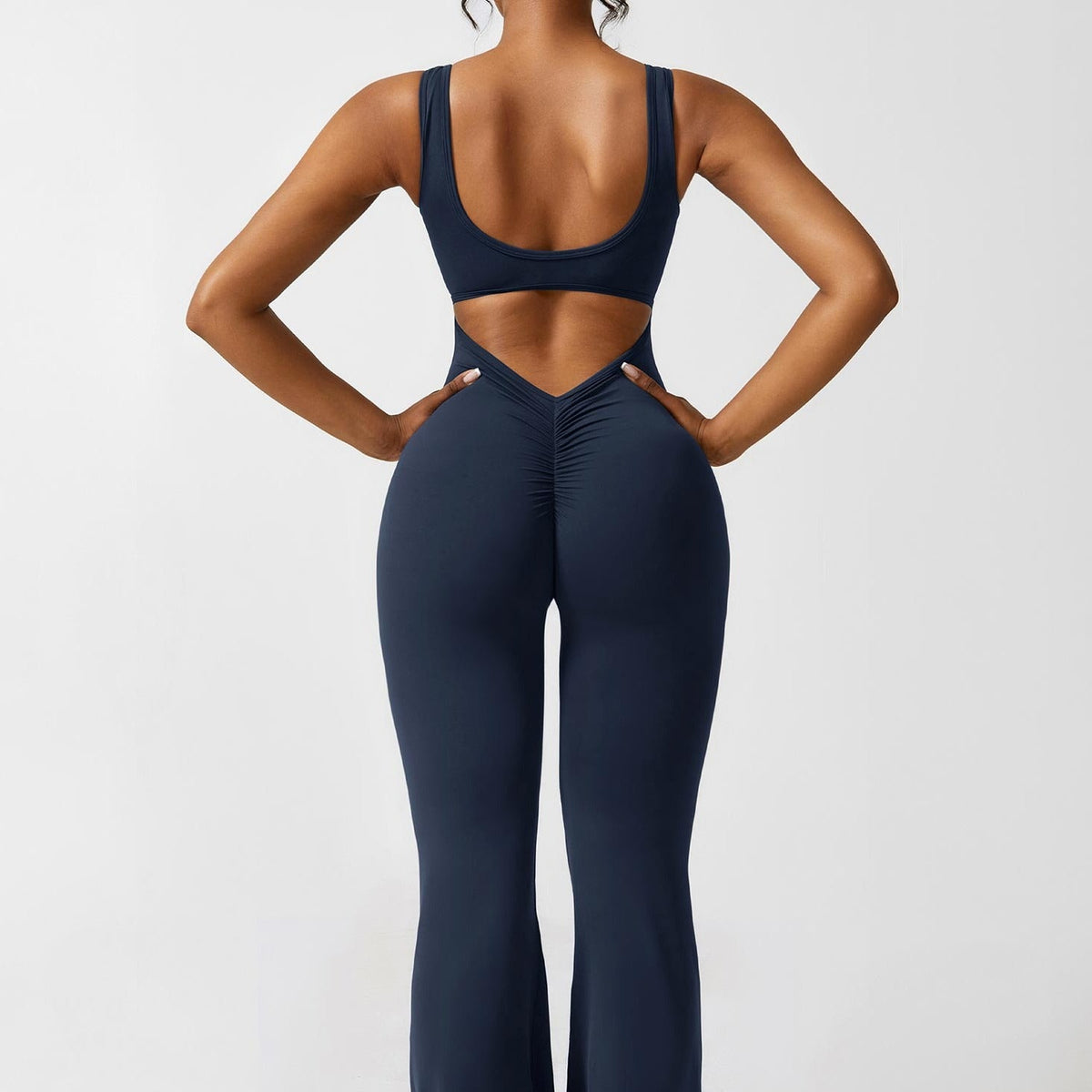 Navy open-back flared jumpsuit with ruched V-back